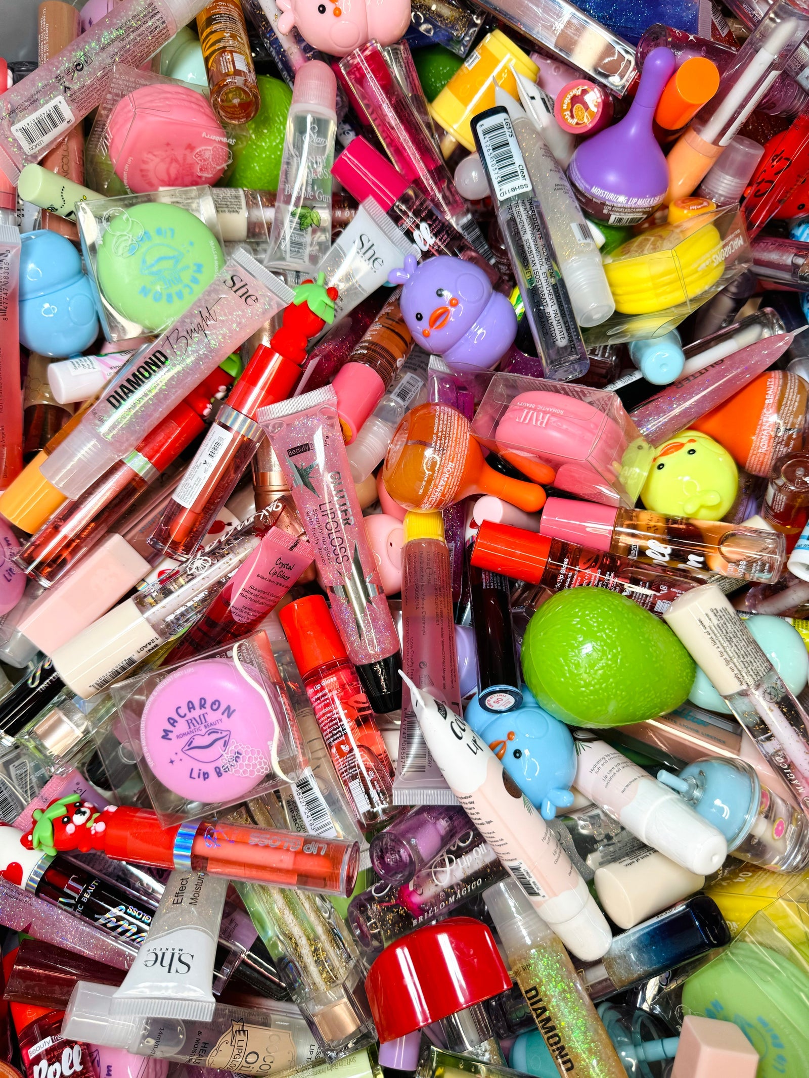 Lip glosses, balms and oils piled together
