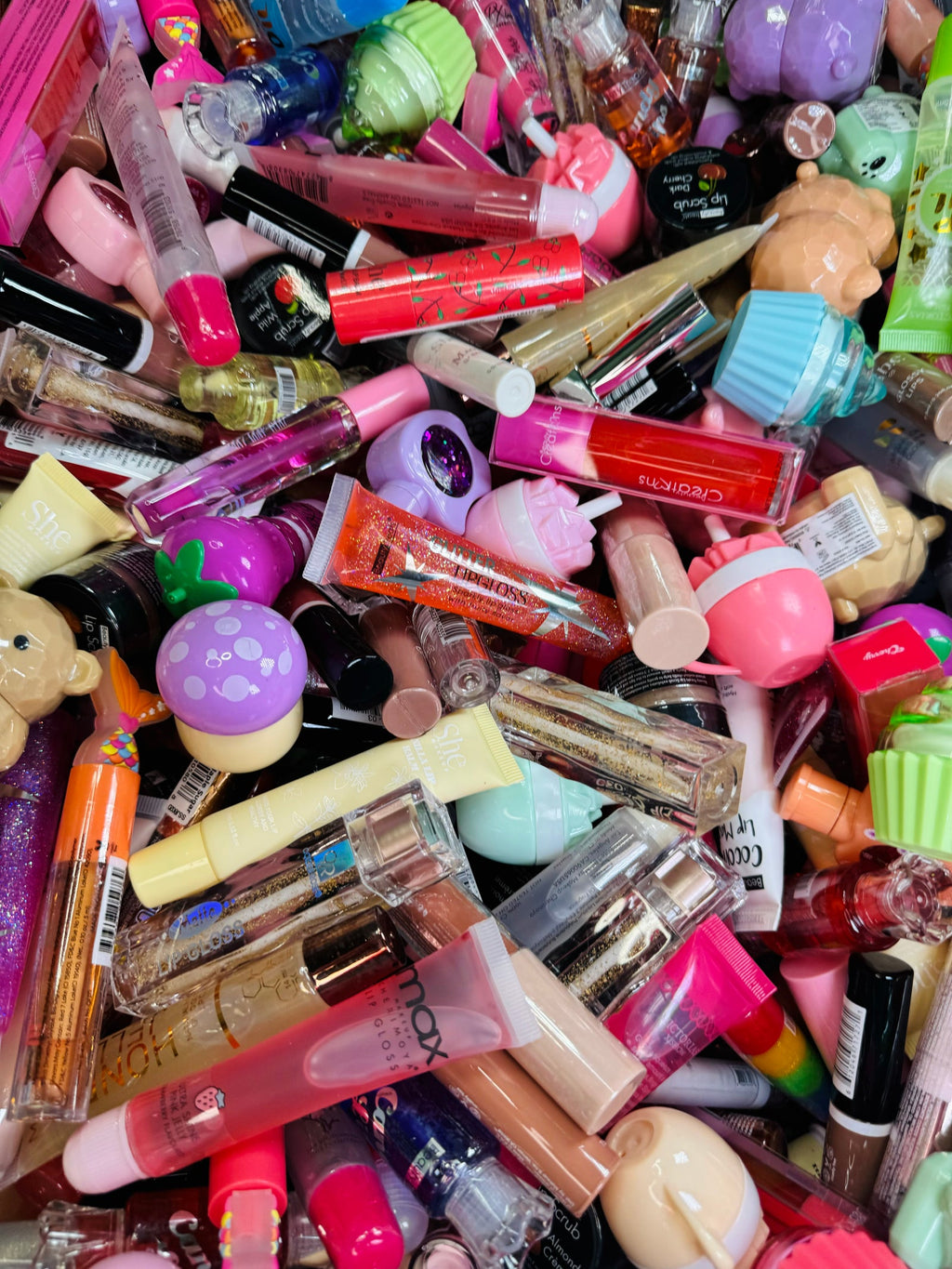 A bin overflowing with lip glosses, ready to be scooped