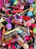 A bin overflowing with lip glosses, ready to be scooped