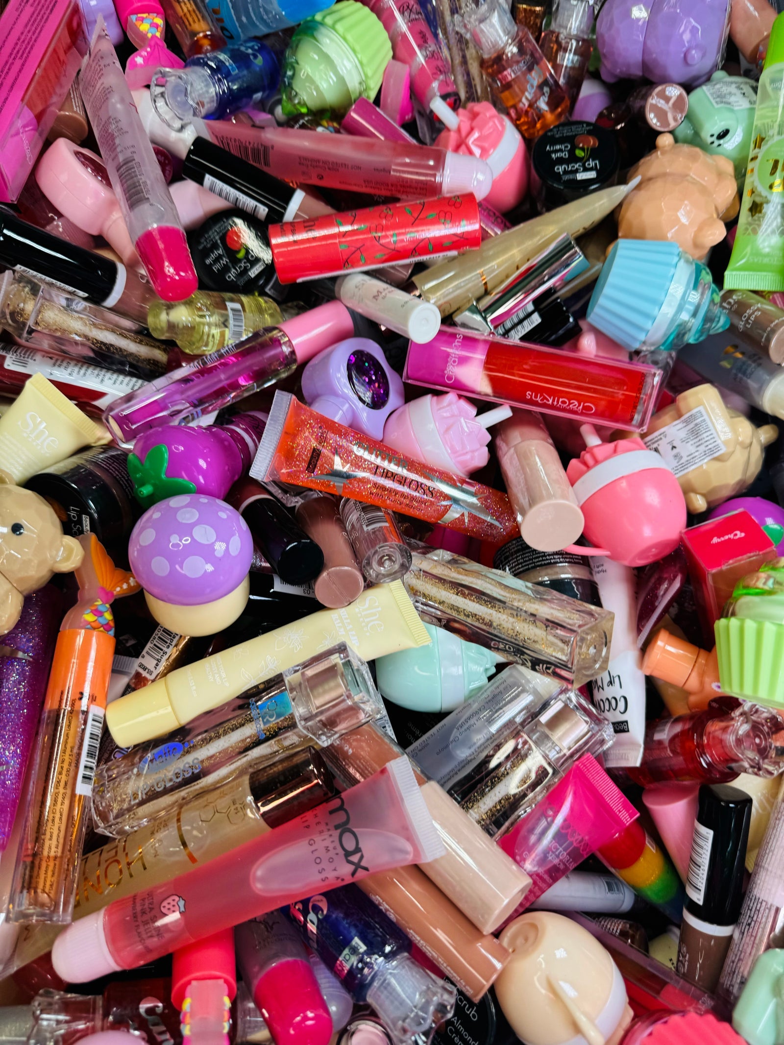 A bin overflowing with lip glosses, ready to be scooped