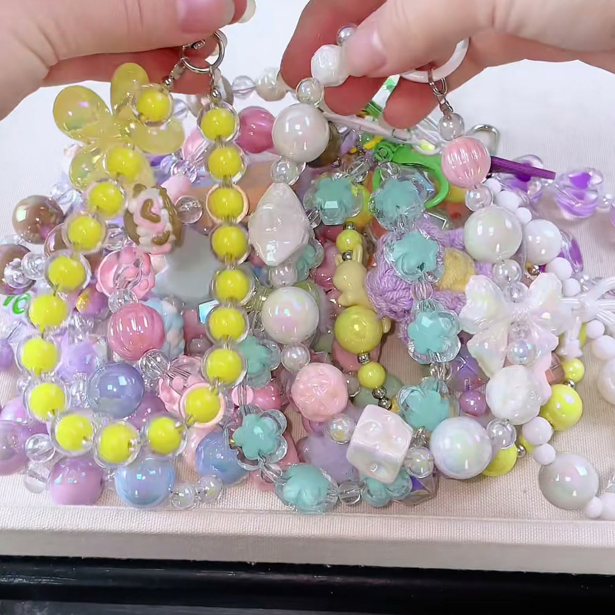 A handful of bead keychains from the Charm Vault