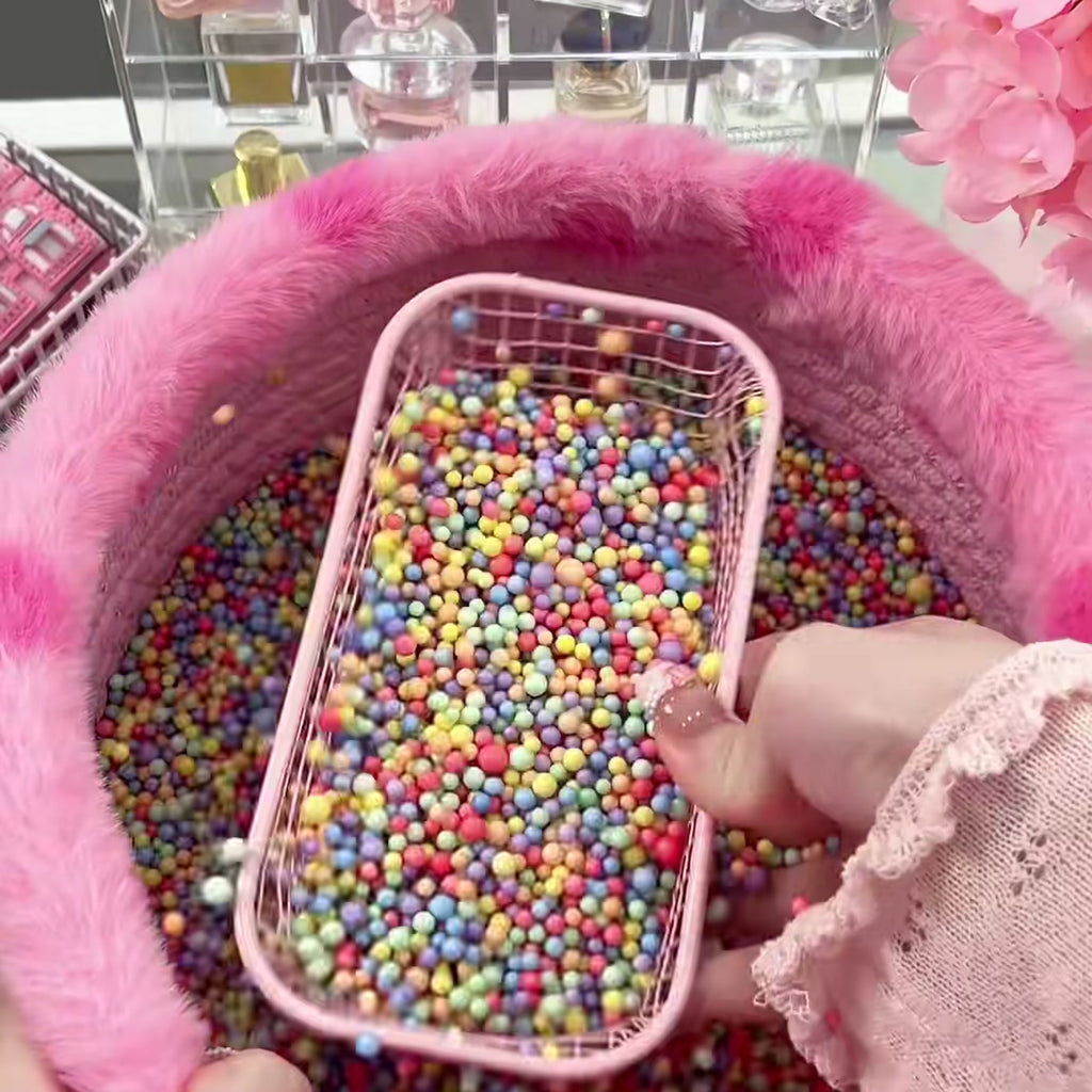 The pink scoop bin with the basket of lucky beads